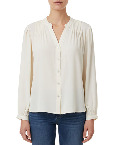 White blouse with long sleeves worn by a person on a white background